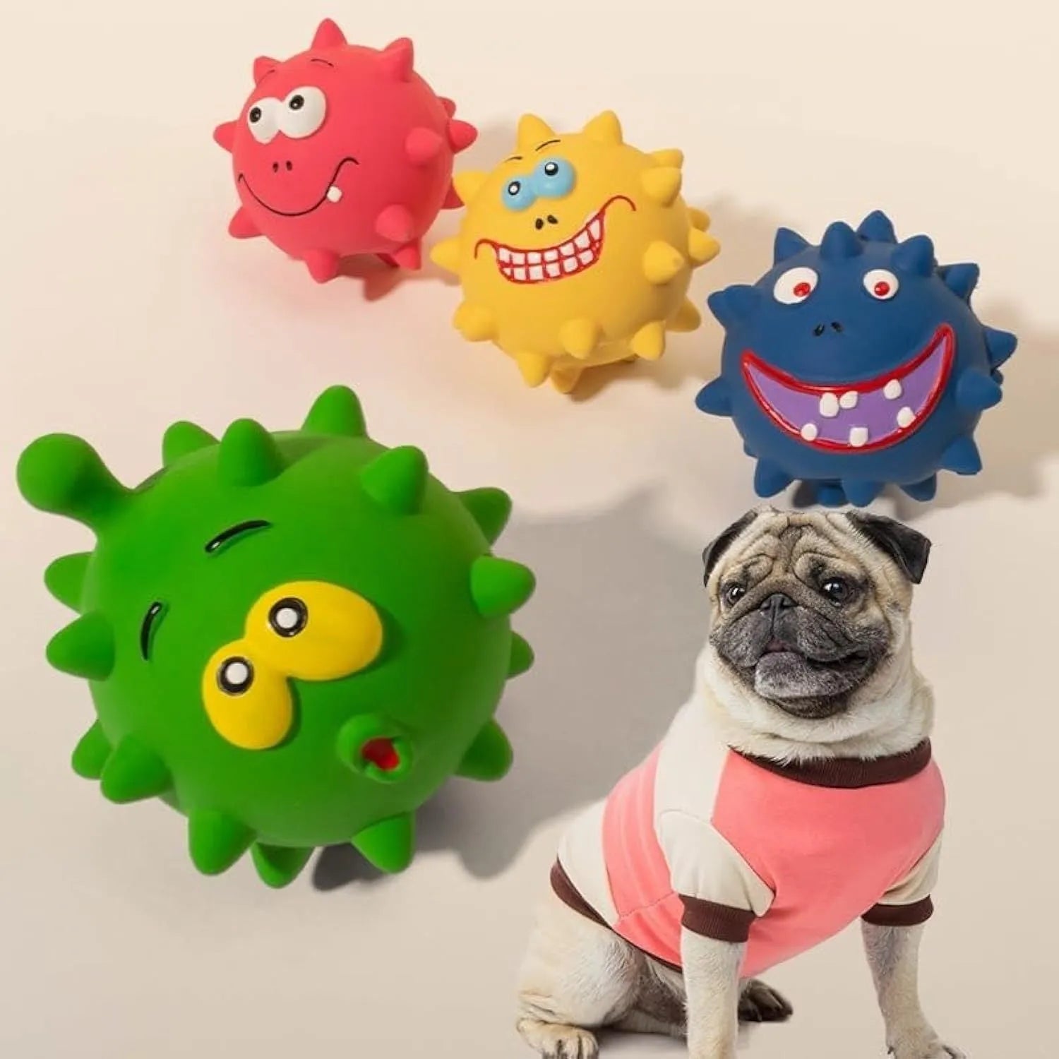 Four colourful squeaky dog balls with cute faces, showing textured surface for dental cleaning, natural latex construction