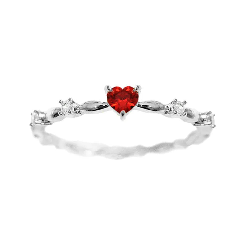 Gold and silver electroplated peach heart ring with zircon stones on a copper base.