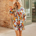 Orange floral and striped print long sleeve V-neck mini dress with lace detail on hanger.