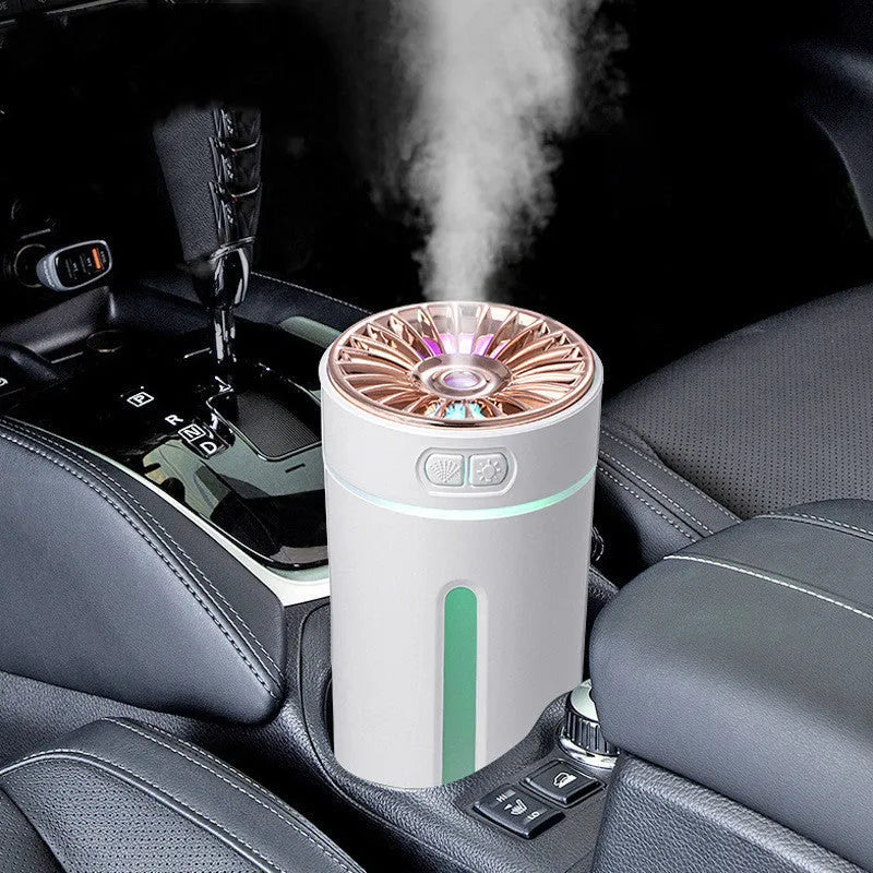 Black portable USB rechargeable humidifier with colourful LED lights on a car cup holder.