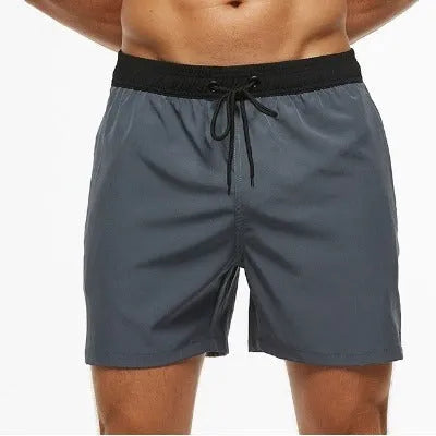 Men's blue athletic shorts with multiple pockets, drawstring waistband, and stitching detail for running and fitness activities