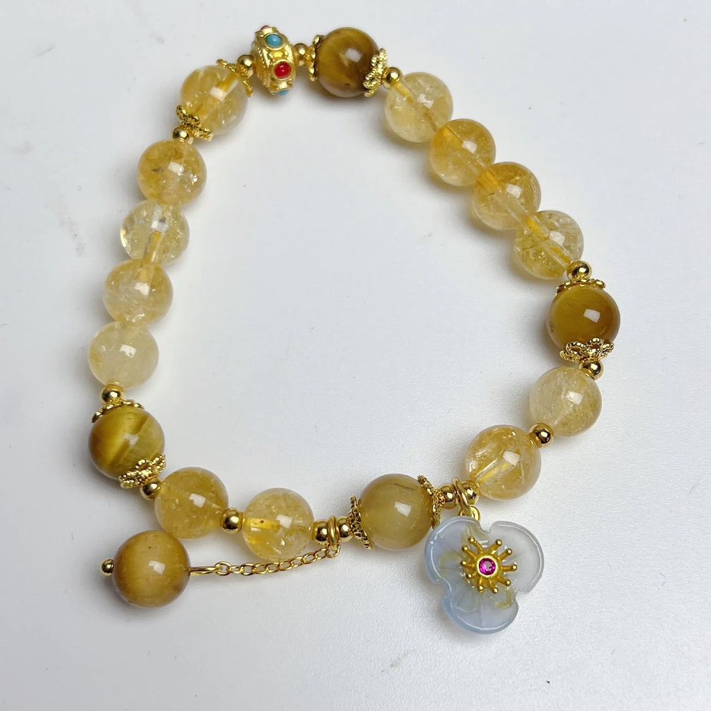 Handcrafted citrine crystal bracelet for women with a flower and tassel design.