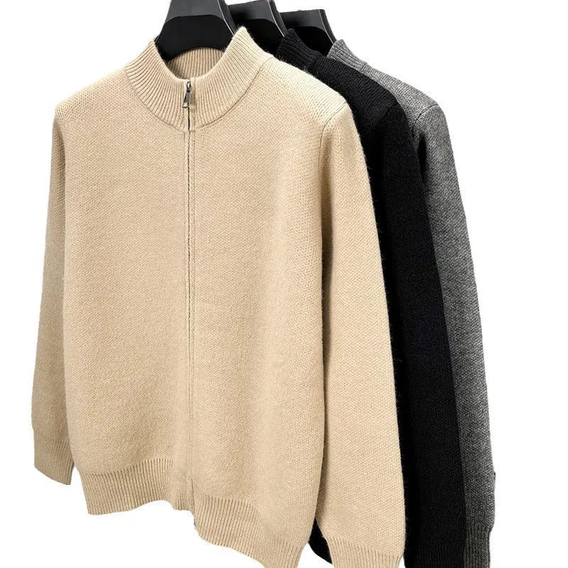 Man wearing a beige high collar knitted cardigan with a full-length front zipper, showing loose fit.