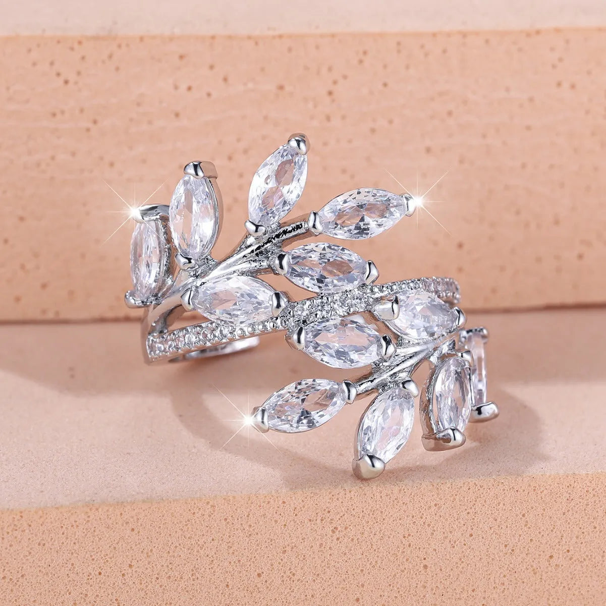 Adjustable copper leaf ring with horse eye zircon stones in multiple colour options showing botanical design