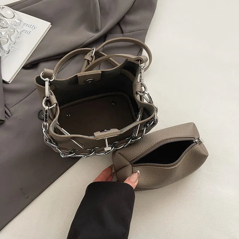 Soft black PU leather retro bucket shoulder bag showing interior phone and zipped pockets.