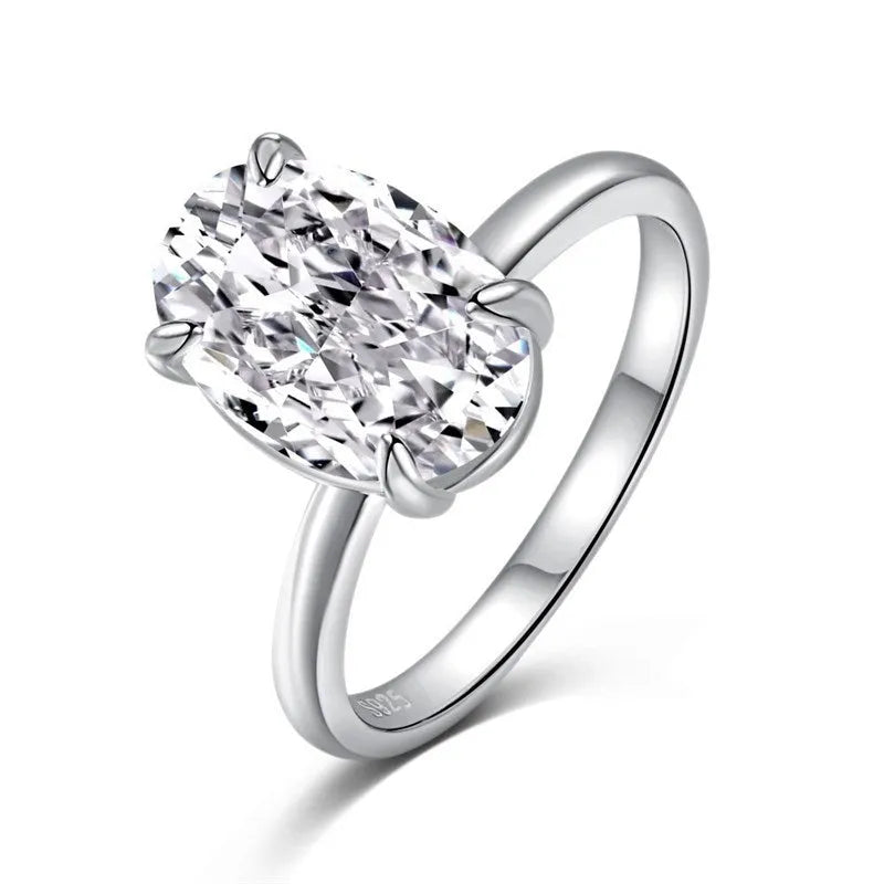 Oval women's ring in 9 silver with four-claw setting holding a 6x9mm gemstone, shown in gold and silver finishes.