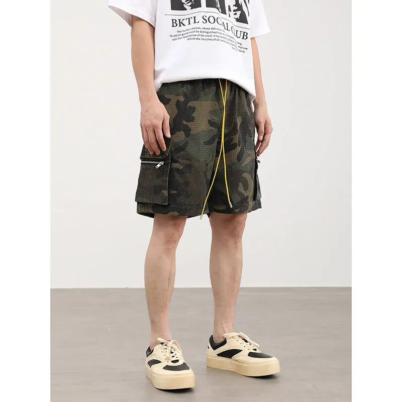 Men's camouflage multi-pocket work shorts showing cropped length and pocket details