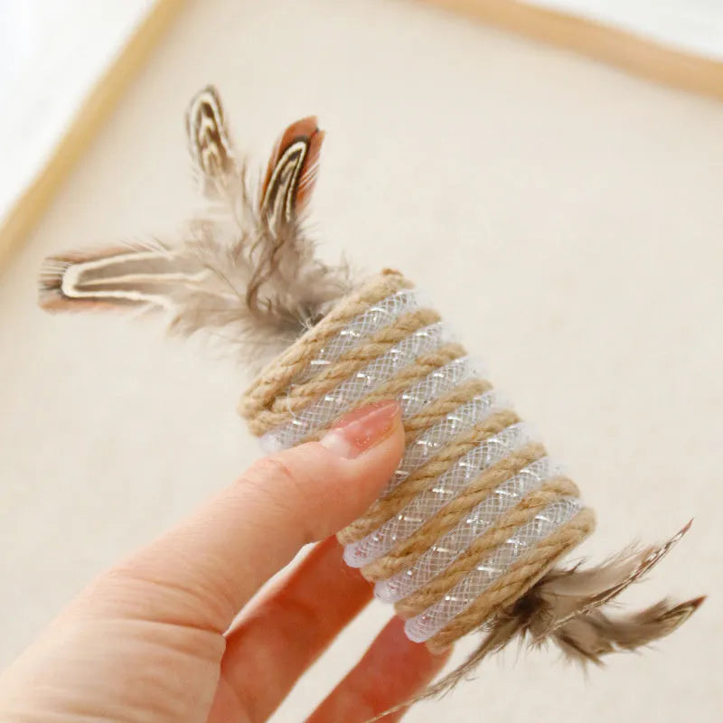 Beige cat interactive toy with feathers, hemp rope scratching surface, and integrated sound roller mechanism