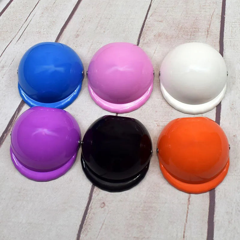 Small dog wearing a solid colour plastic motorcycle-style cap in a Japanese or Korean pet fashion style.