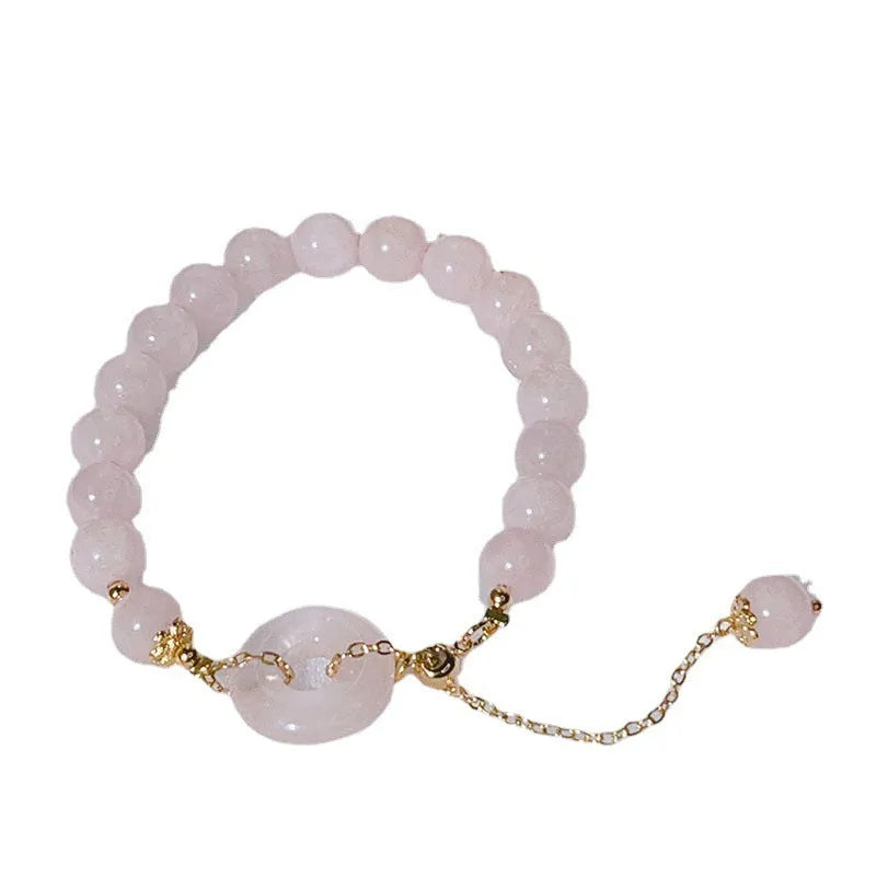 Women's pink crystal bracelet with peace buckle safety closure on wrist