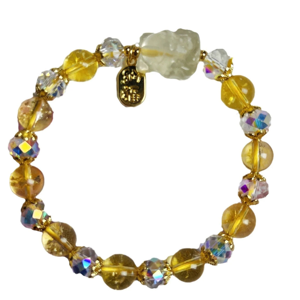 Close-up of an adjustable natural citrine crystal bracelet featuring a handcrafted nine-tail fox design on a white background.