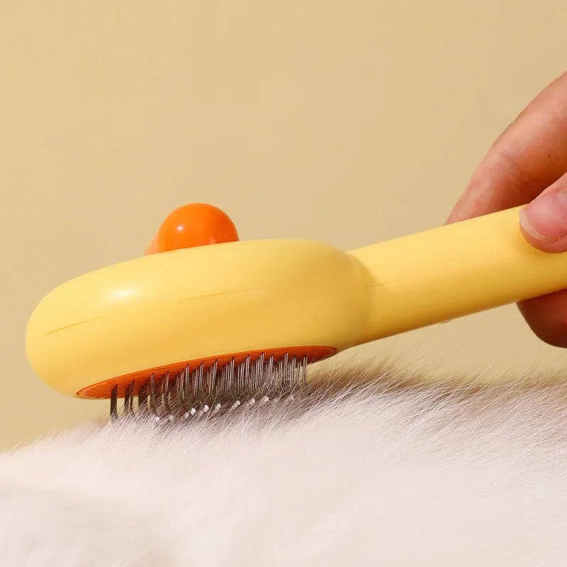 Small yellow duck-shaped comb for pet grooming with open section and needle bristles