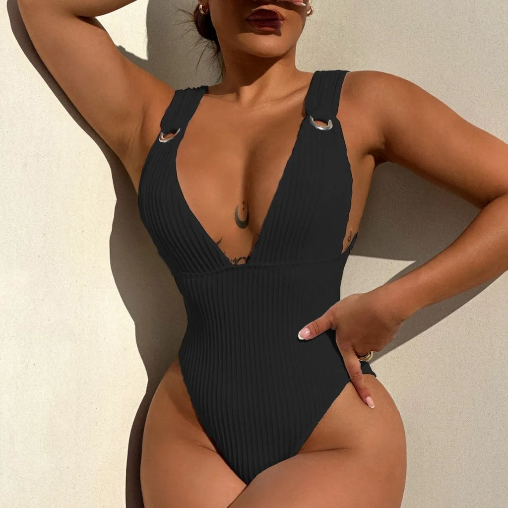 Solid colour one-piece swimsuit for women on a hanger, showing spandex lining and available in black, white, green, orange.