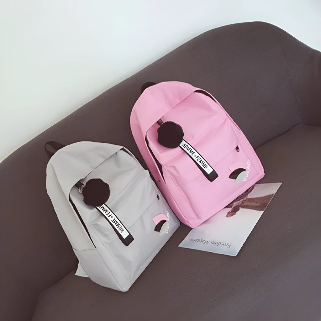 Casual canvas college schoolbag with leaf pattern in green, shown with size and anti-theft features.