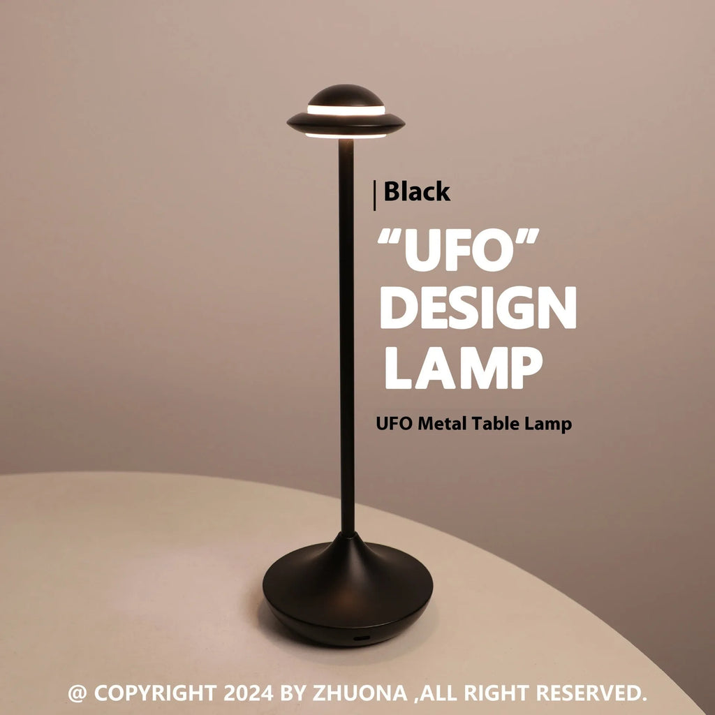 UFO Table Lamp in black with touch dimming panel and rechargeable design on a wooden desk