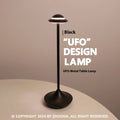 UFO Table Lamp in black with touch dimming panel and rechargeable design on a wooden desk