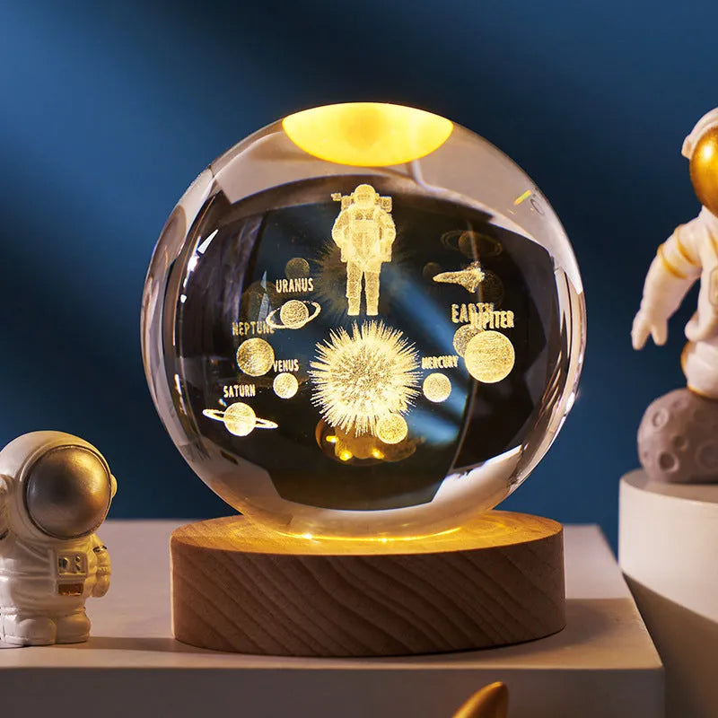 3D crystal ball night light projecting starry sky and planets from its 6cm sphere on a solid wood base.