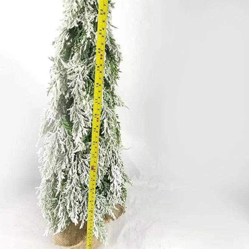 24-inch desktop Christmas tree with PE snow simulation and integrated lighting on wooden surface