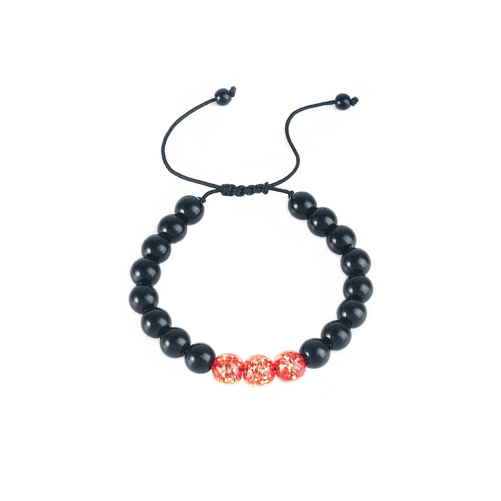 Geometric adjustable bracelet with luminous glass beads in sapphire blue on a wrist.