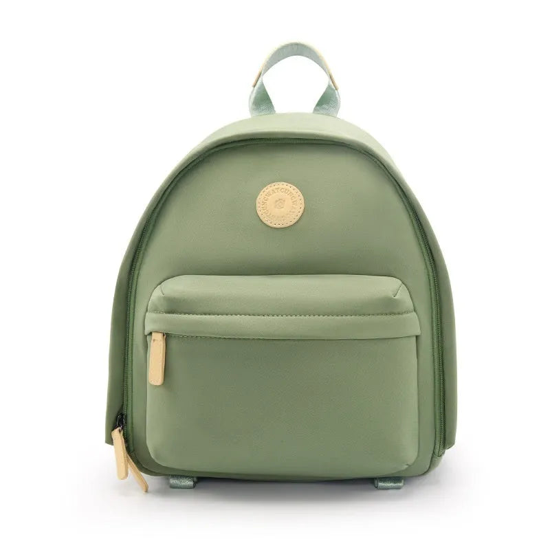 Green polyester shoulder camera bag for women with a curved strap and front patchwork panel.