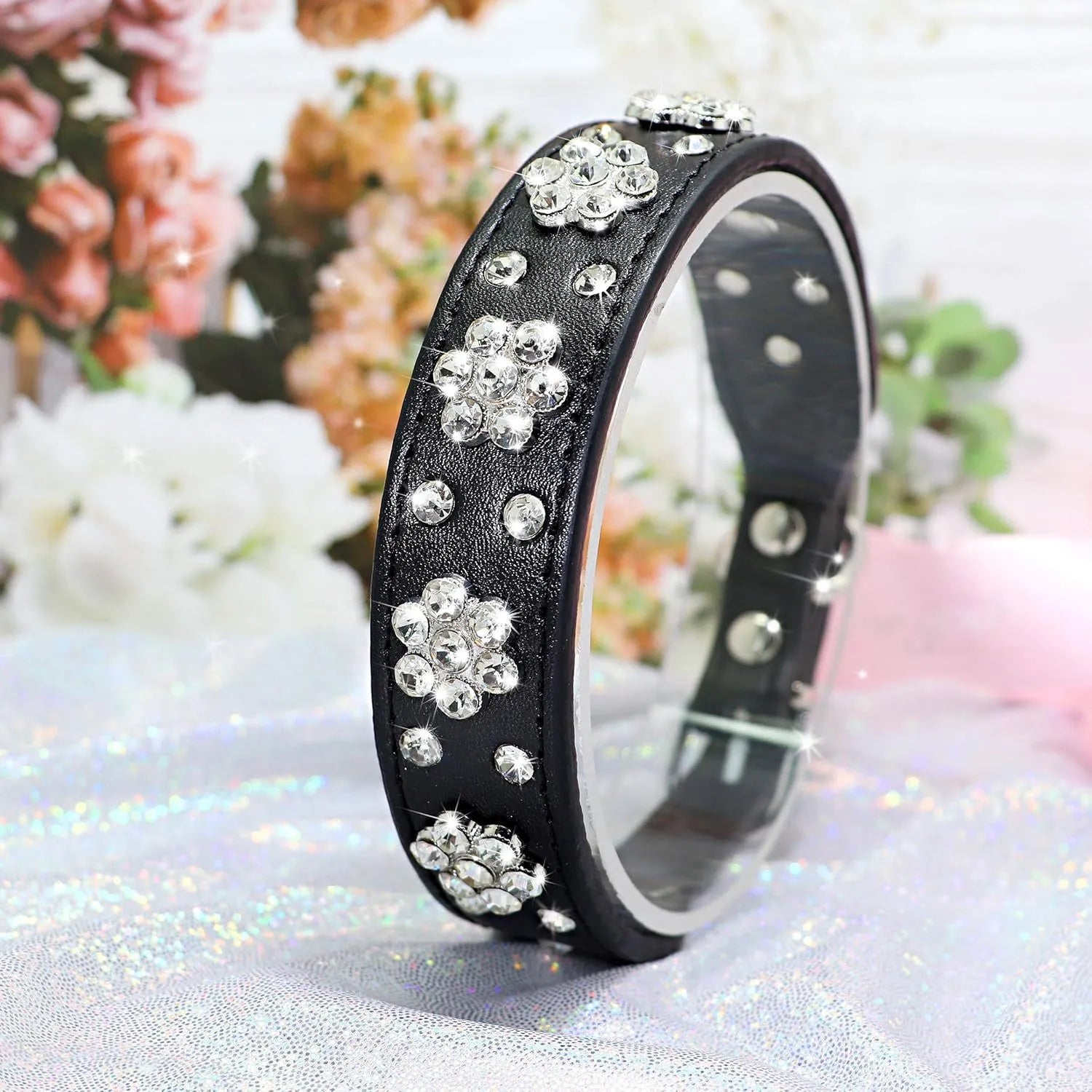 Black PU leather dog collar with rhinestone flower pattern and studded design, adjustable with metal eyelets
