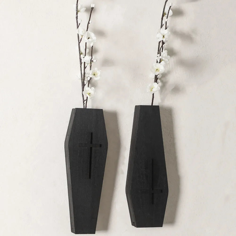 Black cross-shaped wooden wall shelf measuring 27 by 9 centimetres
