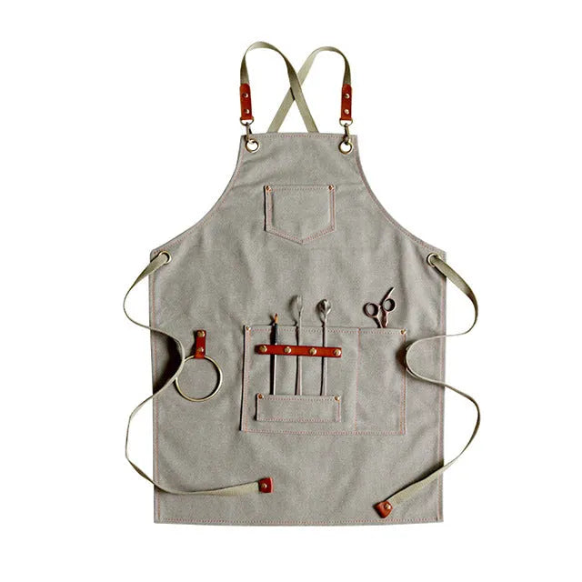 Canvas apron with cross-back straps in camel colour, shown on a person for milk tea shop or cafe use