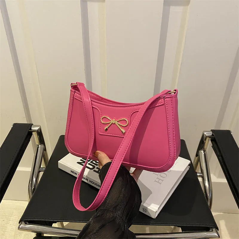 Horizontal square PU leather shoulder bag with a bow decoration, shown in multiple colours.