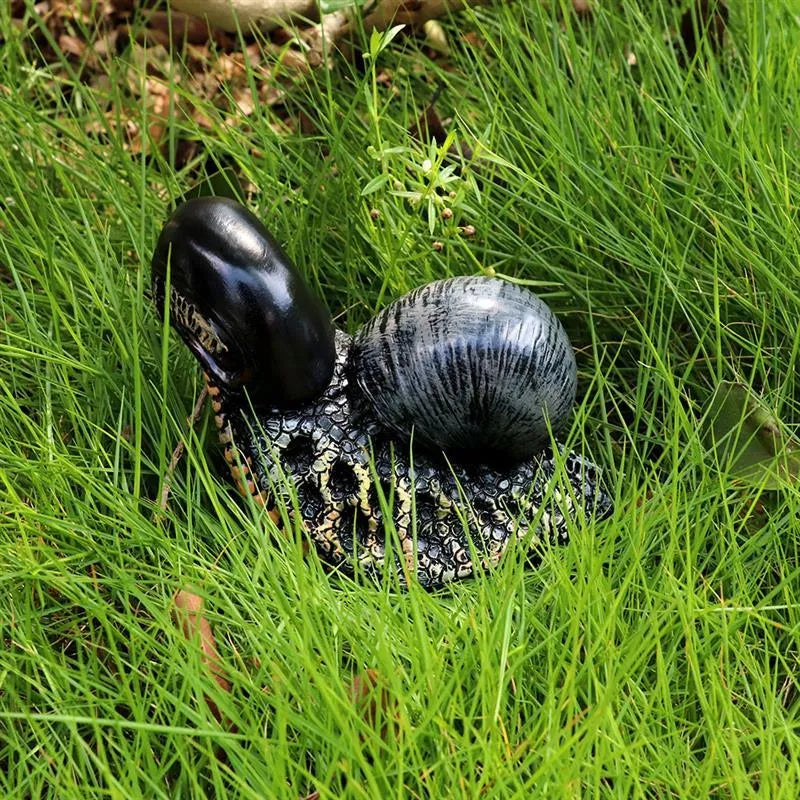 Minimalist white resin snail sculpture on a wooden surface for home or garden decor.