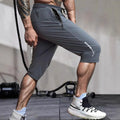 Men's cropped sports pants in blue with quick-drying nylon fabric and elastic waistband