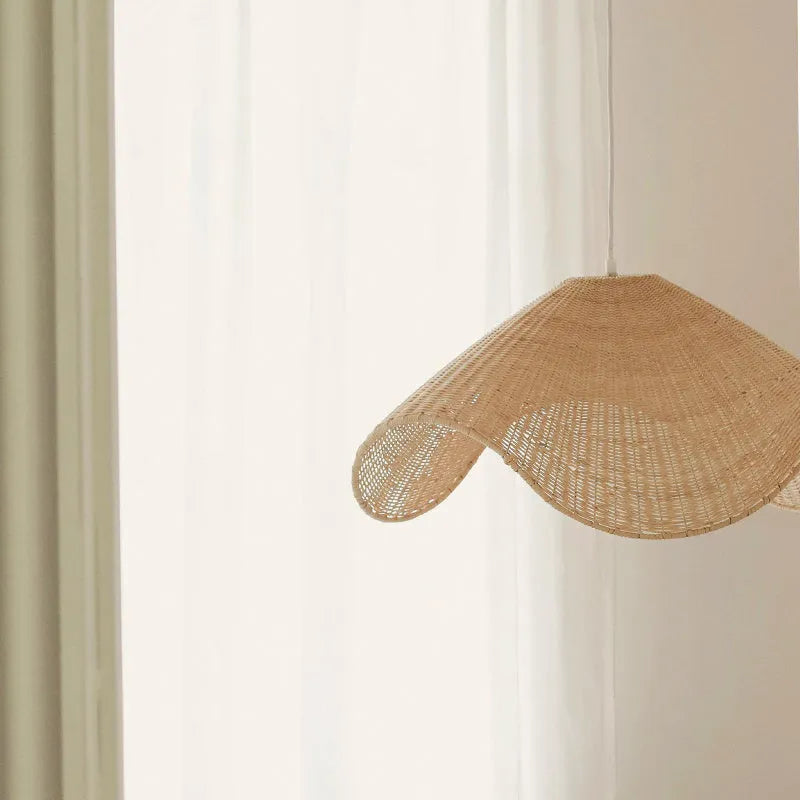 Handmade natural rattan and willow chandelier with warm LED light in three size options.
