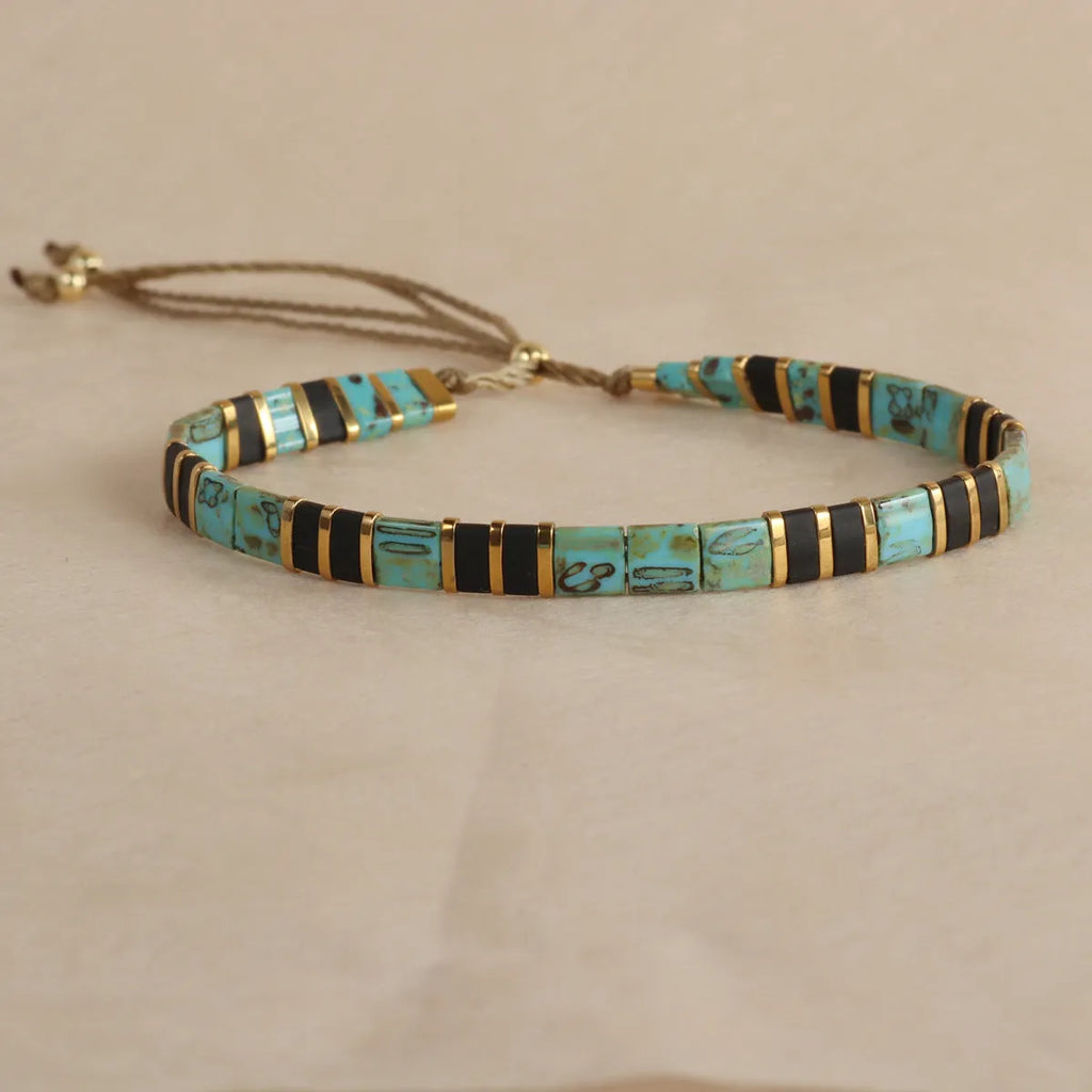 Geometric glass beads bracelet in five colour options showing 8mm beads and secure clasp on wrist