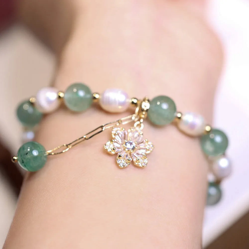 Green strawberry-shaped freshwater pearl bracelet with Chinese knot closure and small flower pendant