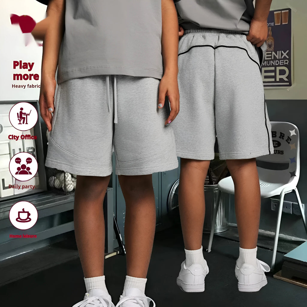Children's loose fit cotton sports shorts in solid colours on a size chart