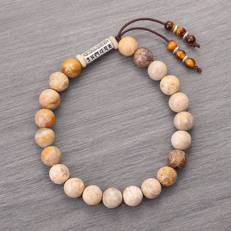 Handmade natural stone bead bracelet in a wood tone colour on a white background.