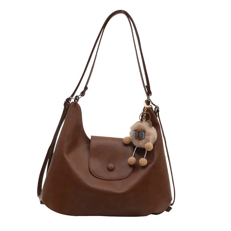 Textured PU leather women's single strap shoulder bag in a horizontal square shape, shown in black colour.