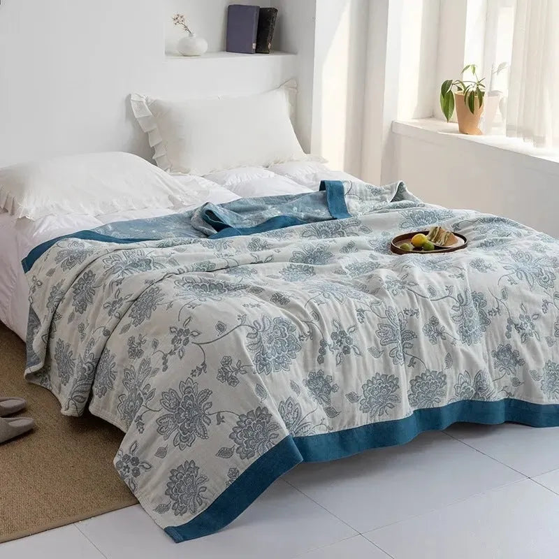 Five-layer gauze bed sheet blanket in Roulette Wheel Blue pattern on a bed