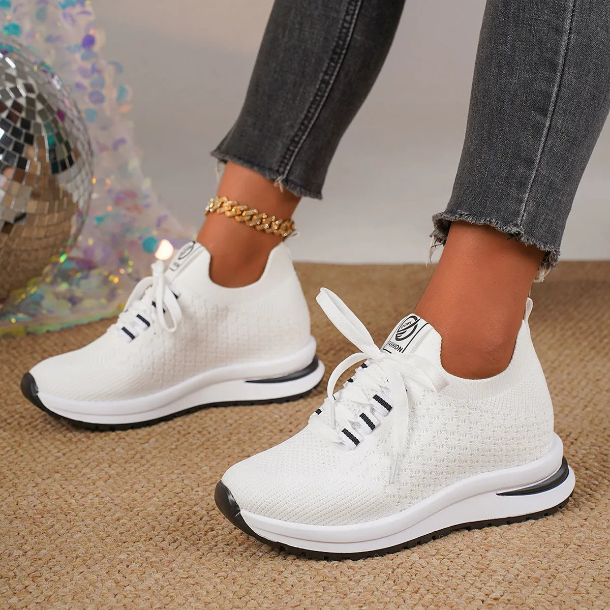 Women's black and white flat lace-up mesh sneakers on a white background