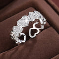 Adjustable geometric couples ring with love heart elements in gold or silver colour, showing opening mechanism