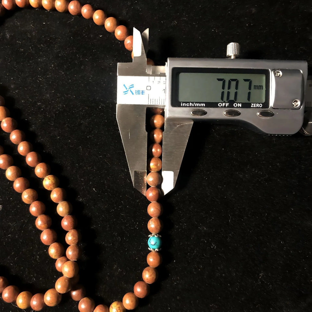 Handmade geometric stone bead bracelet with 108 polished beads in natural colour
