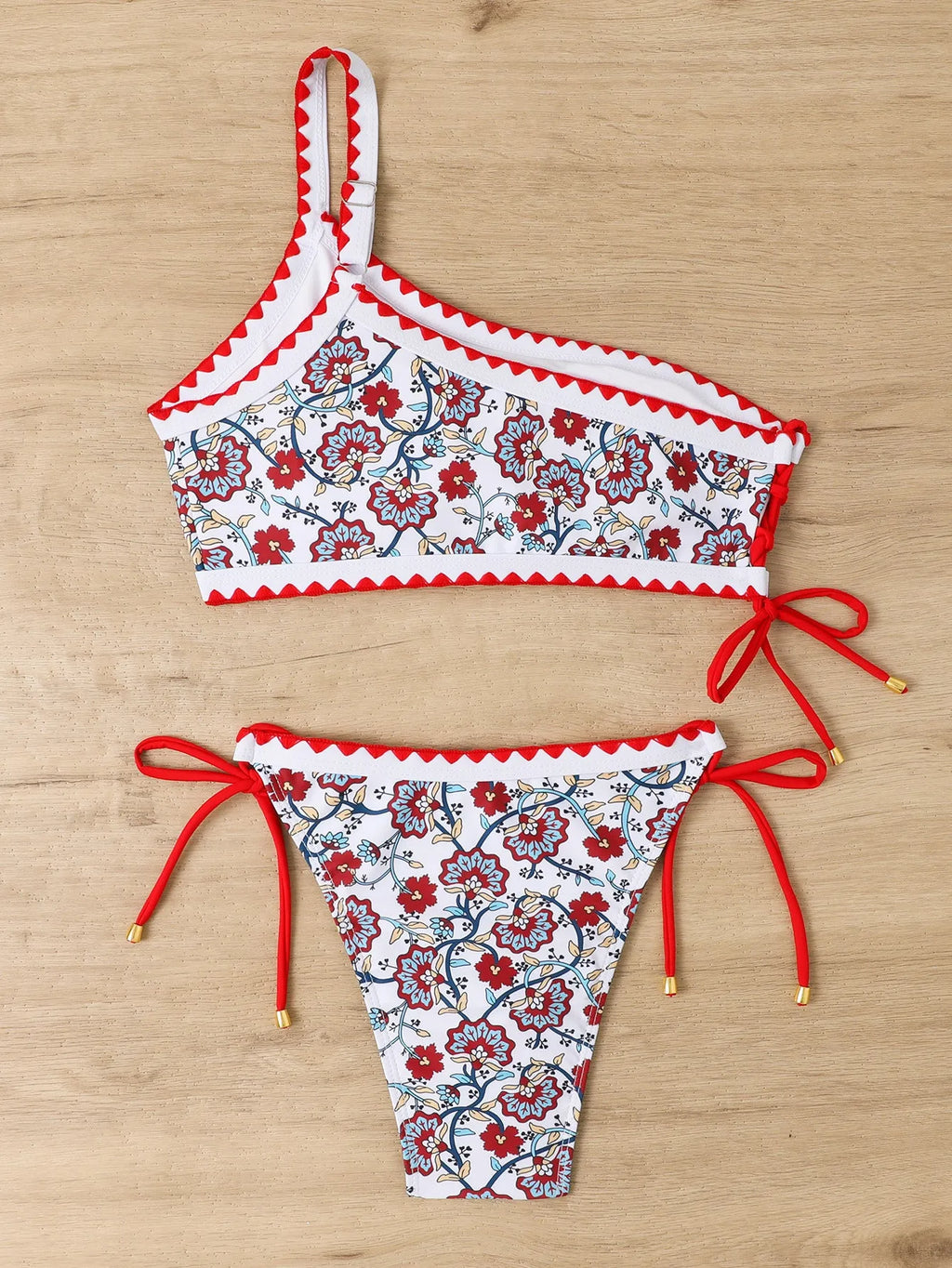 Blue one-shoulder floral bikini set on mannequin showing asymmetrical design and briefs bottom