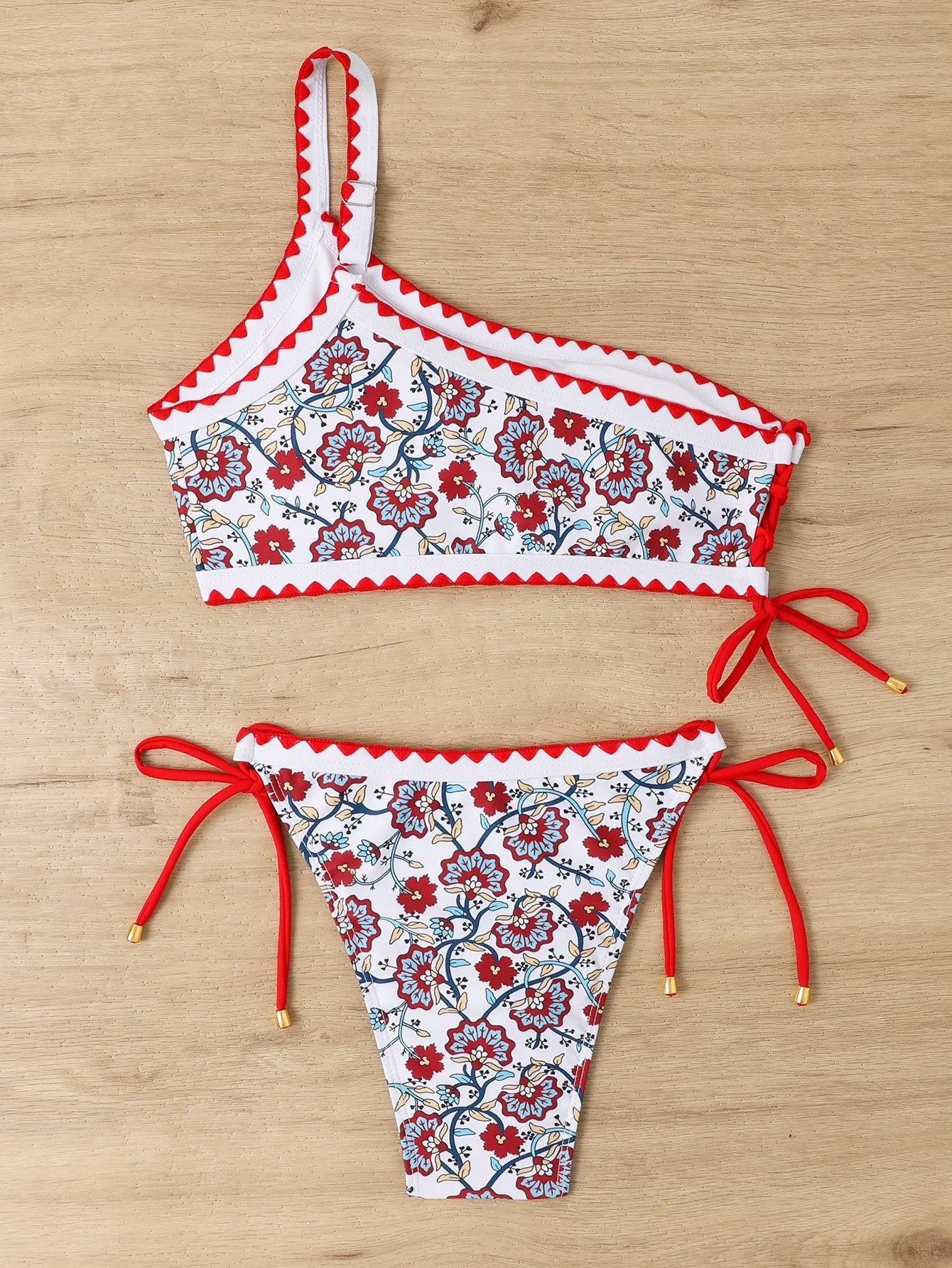Blue one-shoulder floral bikini set on mannequin showing asymmetrical design and briefs bottom