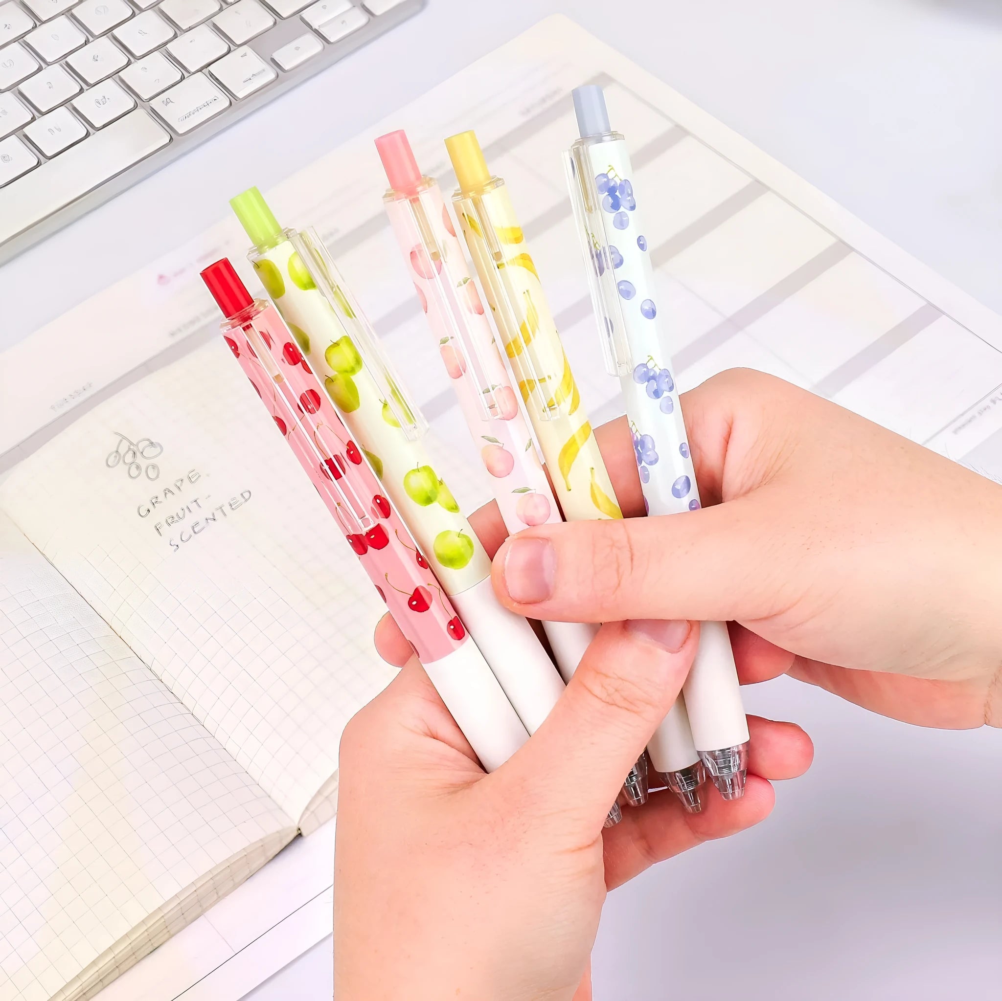 Three fruit-scented press pens with 0.5mm black ink refills and plastic barrels