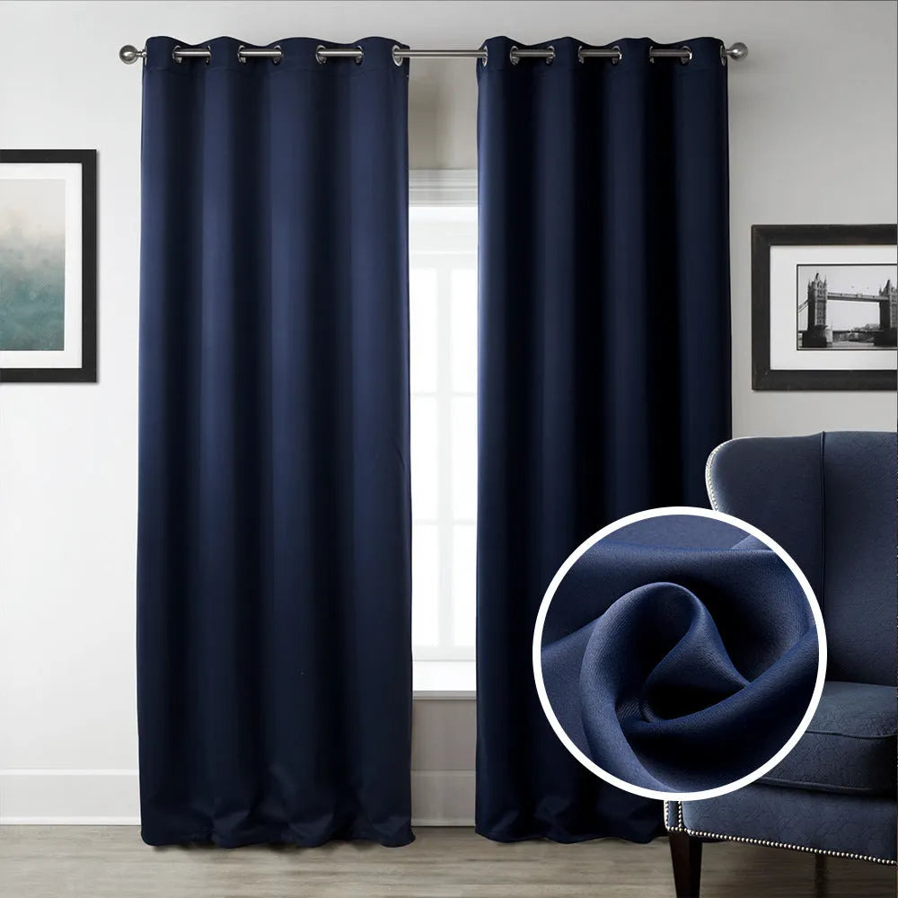 Navy blue blackout curtains with shading cloth fabric in vertical design, showing printed surface and perforated top for hanging