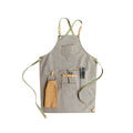 Canvas apron with cross-back straps in camel colour, shown on a person for milk tea shop or cafe use