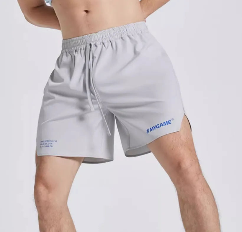 Men's midnight blue training fitness shorts with moisture-wicking fabric on a gym background.