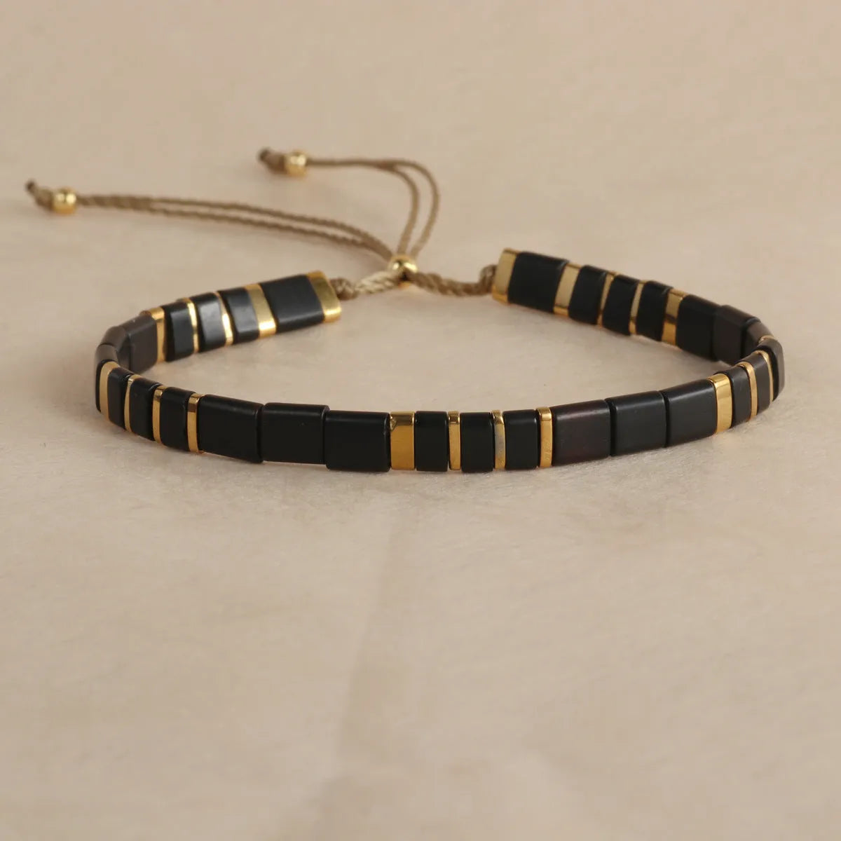 Geometric glass beads bracelet in five colour options showing 8mm beads and secure clasp on wrist