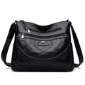 Black soft PU leather shoulder bag with crossbody strap, showing 30cm width and zippered internal organiser
