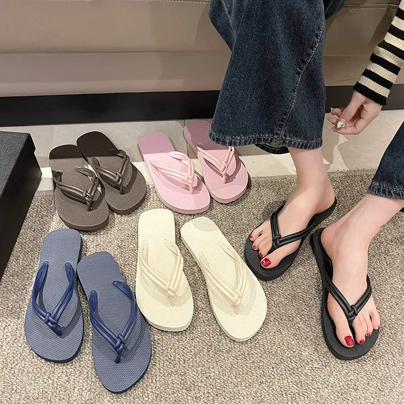 PVC women's flip flops in pink with a non-slip sole and toe-covering strap.