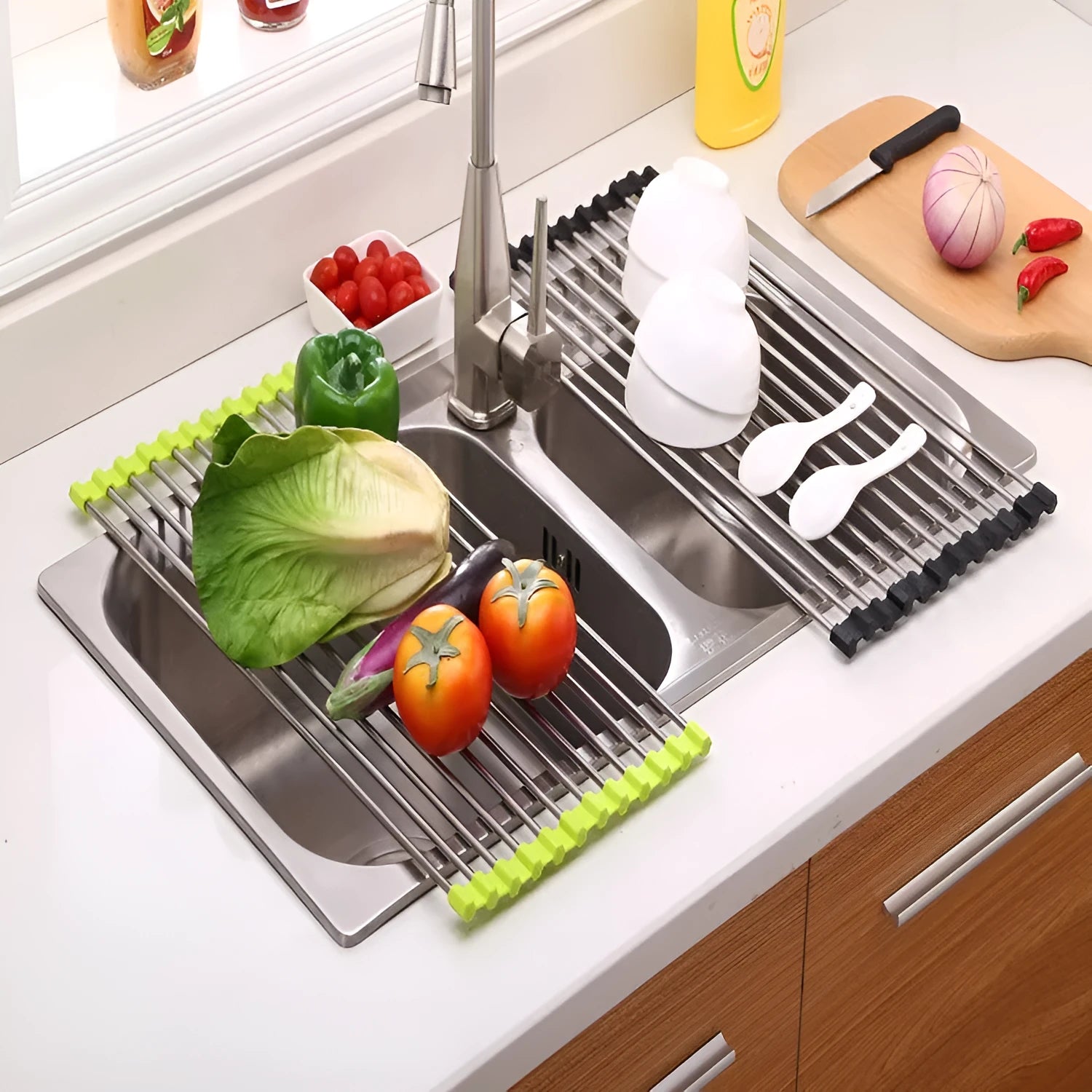 Folding stainless steel dish drainer rack in blue, shown over a kitchen sink
